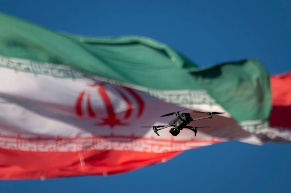 A drone flies in front of an Iranian flag in southern Tehran, Iran, on December 29, 2024.