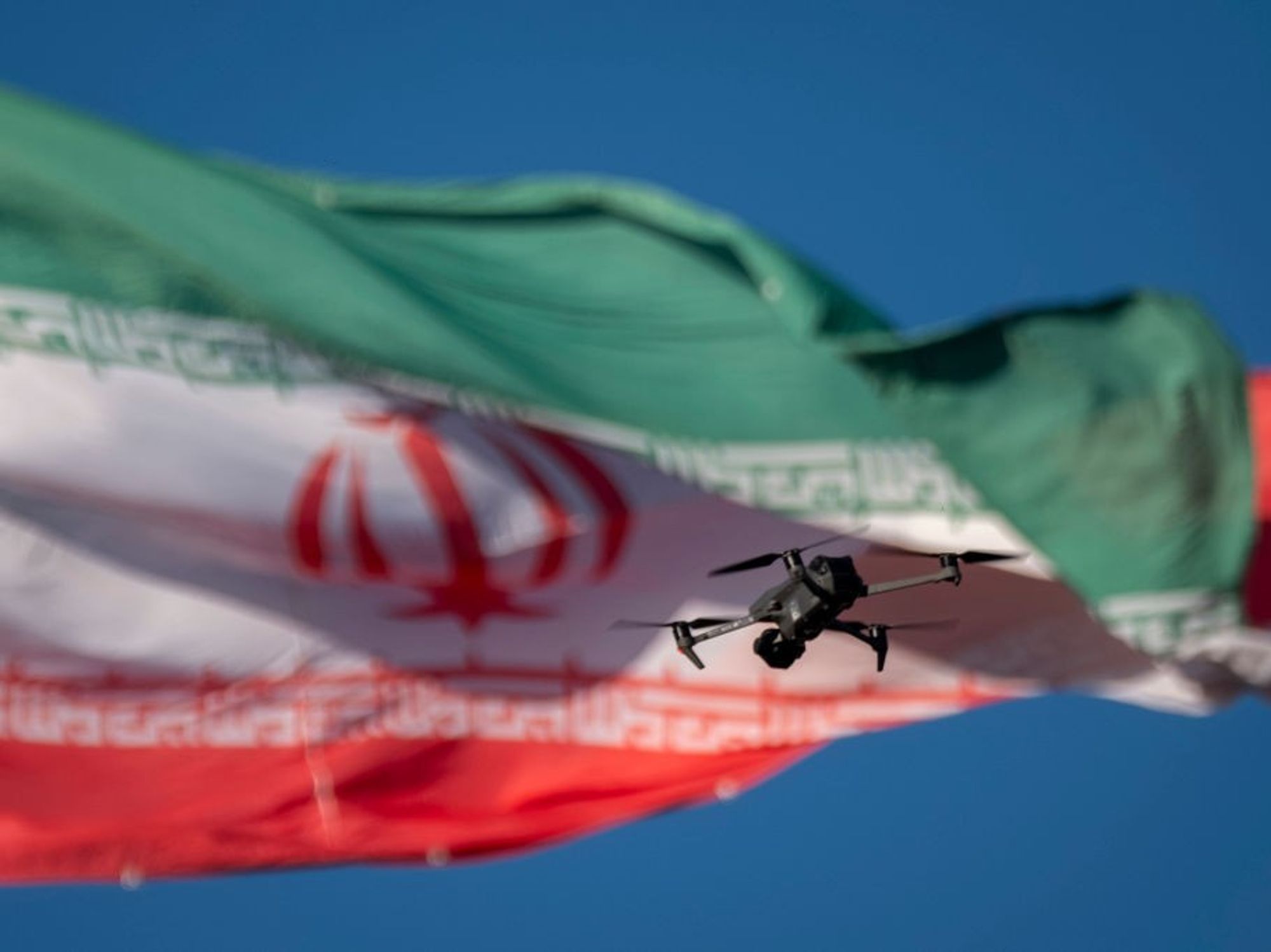 A drone flies in front of an Iranian flag in southern Tehran, Iran, on December 29, 2024.