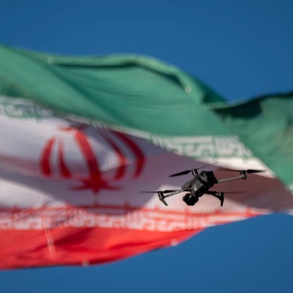 A drone flies in front of an Iranian flag in southern Tehran, Iran, on December 29, 2024.