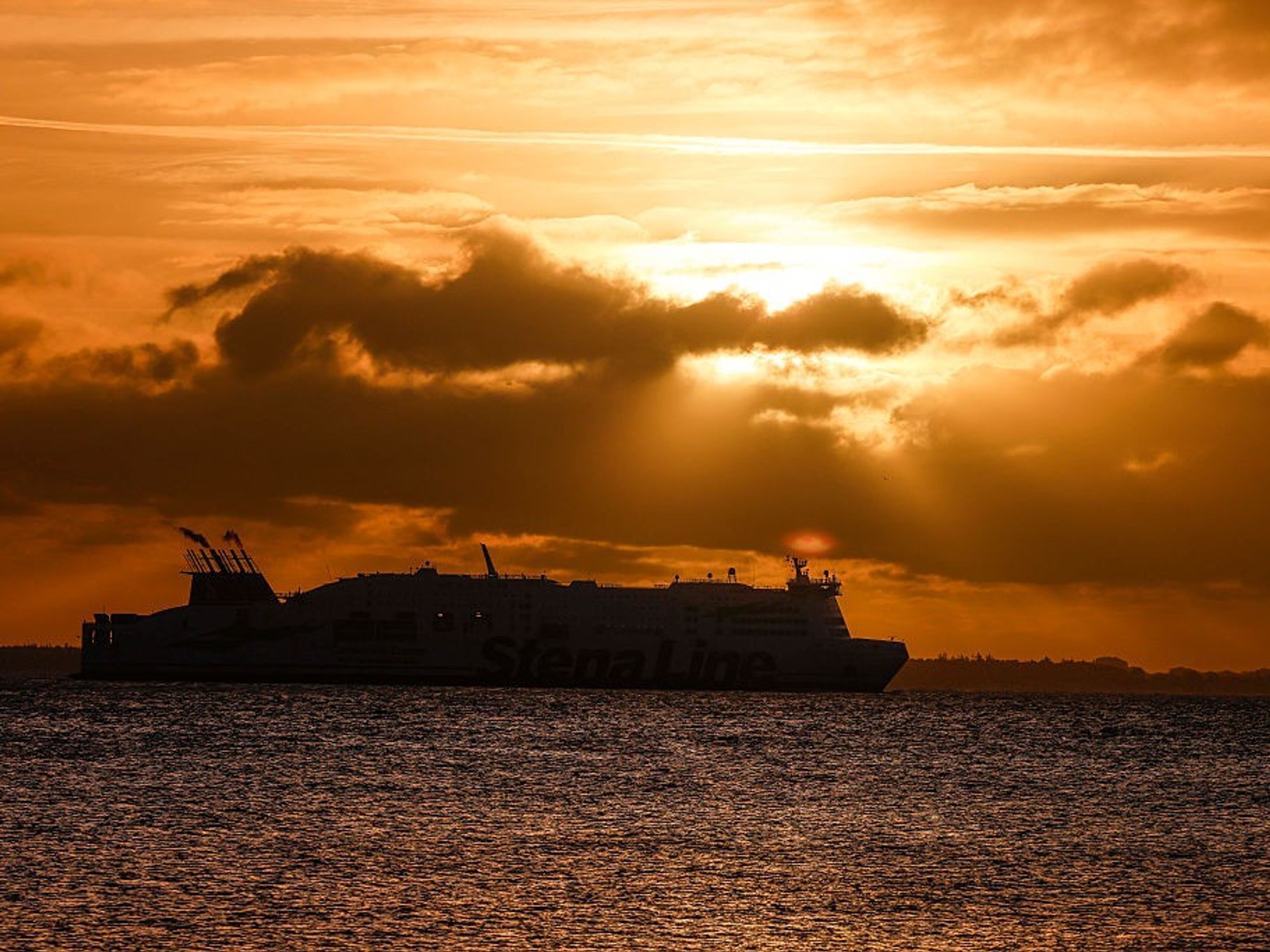 A ship crosses the Baltic Sea at sunrise