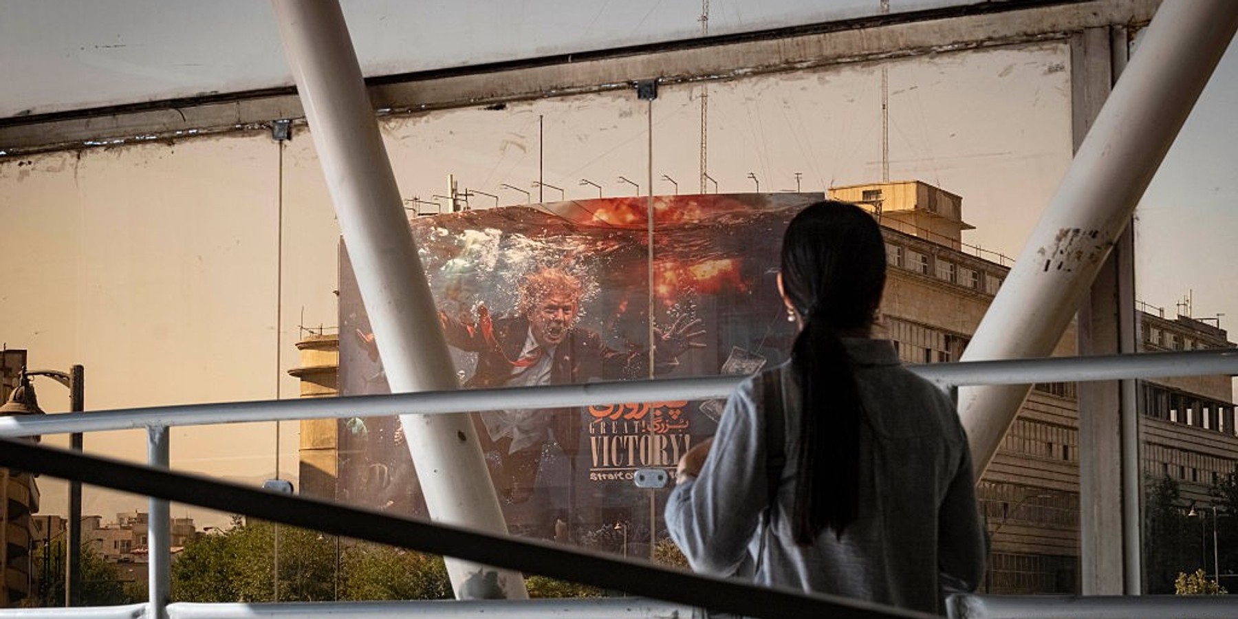 Anti Trump New Billboard In Tehran A young Iranian woman walks past a billboard featuring President Donald Trump and the slogan ''Great Victory, Strait of Hormuz'' in southern Tehran, Iran, on September 1, 2026. U.S. forces struck two Iranian military launchers on Larak Island in the Strait of Hormuz on August 30, the first reported U.S. attack on Iranian territory since late July. (Photo by Morteza Nikoubazl/NurPhoto via Getty Images)
