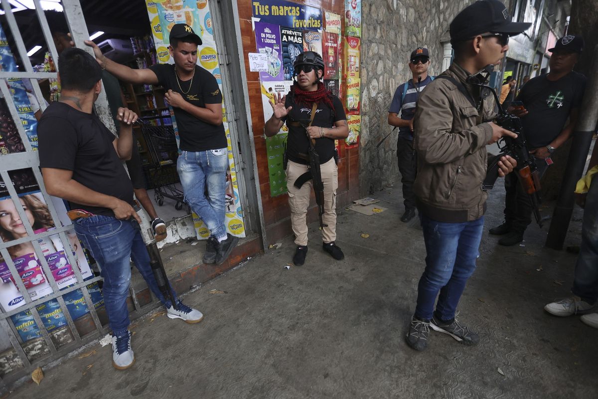 ​Armed supporters of ousted Venezuelan President Nicolas Maduro stand guard