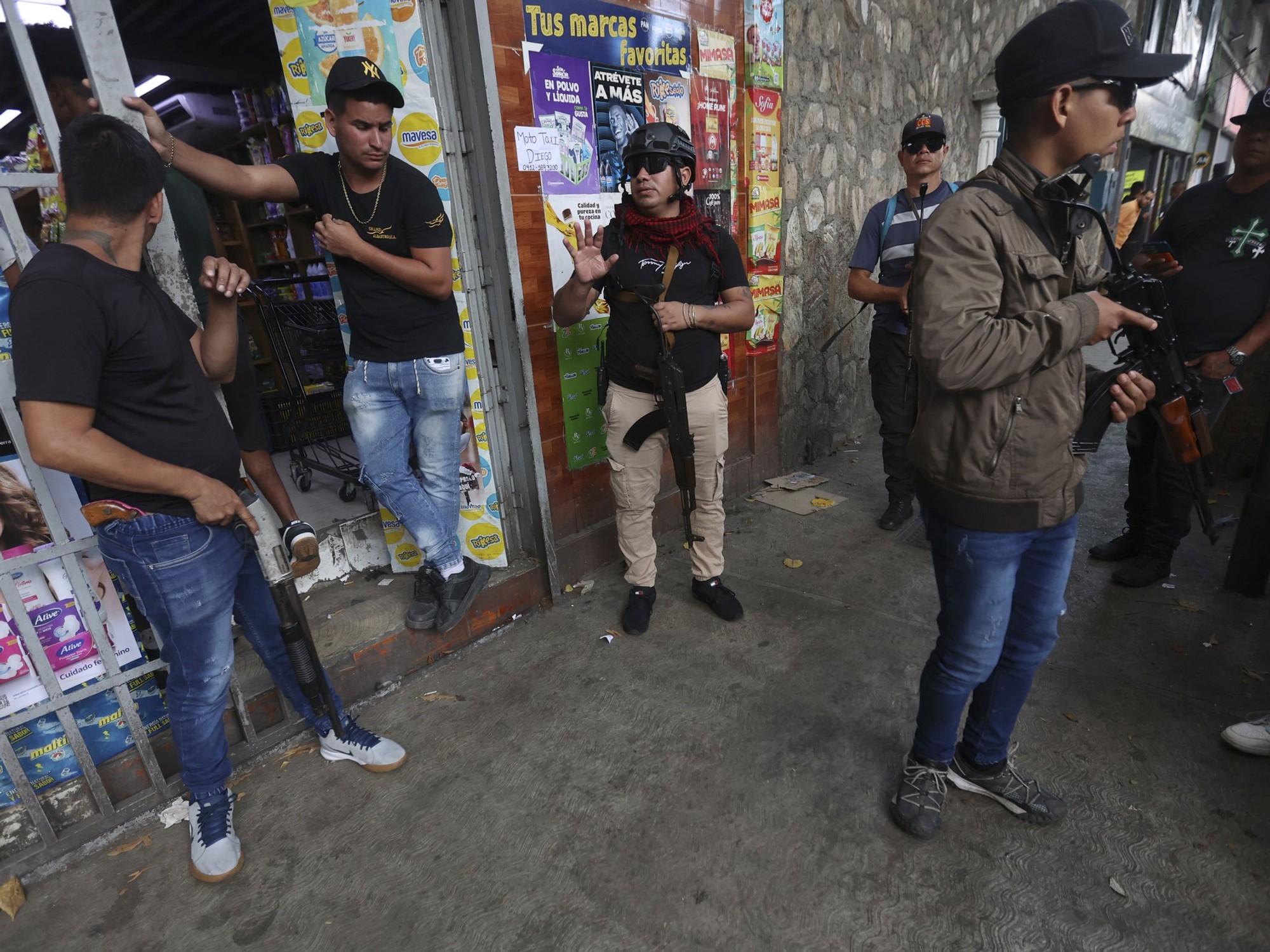 Armed supporters of ousted Venezuelan President Nicolas Maduro stand guard