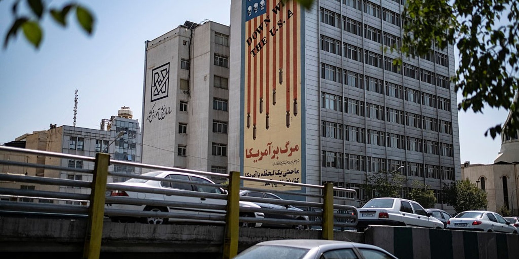 Daily Life In Iran Amid New Conflicts Between Iran And U.S. Vehicles move along an avenue beneath an anti-U.S. mural in Tehran, Iran, on July 16, 2026. This occurs amid new tensions between Iran and the United States. (Photo by Morteza Nikoubazl/NurPhoto via Getty Images)