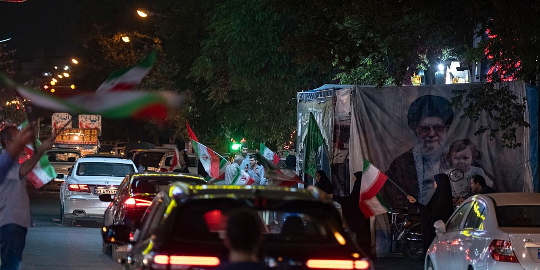 Daily Life In Tehran As Iran-U.S. 60-day Ceasefire Expires Pro-government supporters wave Iranian national flags next to a banner depicting a portrait of Iran's late Supreme leader Ayatollah Ali Khamenei and his granddaughter during a nightly rally near a shopping and fast-food restaurant district in downtown Tehran, Iran, on August 23, 2026, as the Iran-U.S. 60-day ceasefire expires. The 60-day ceasefire between Iran and the United States ended on August 17, with no new agreement reached between the two sides. (Photo by Morteza Nikoubazl/NurPhoto via Getty Images)