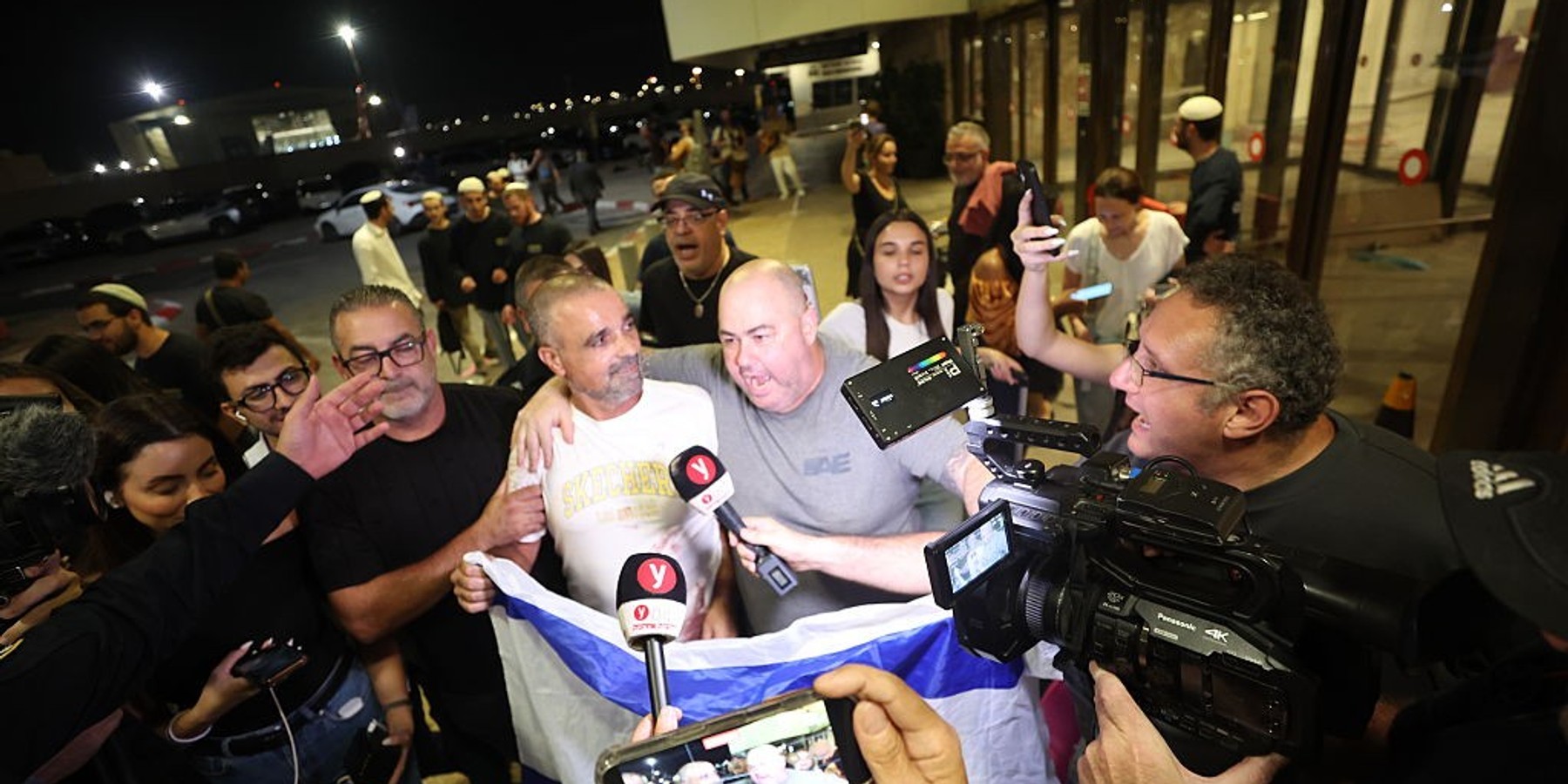 Flydubai passenger plane arrives in Tel Aviv 30 September 2026, Israel, Lod: Yaniv Hayun (C), one of the men who helped incapacitate the attacker on the flydubai aircraft bound for Israel from the United Arab Emirates, which was diverted to Saudi Arabia following an emergency signal, is welcomed after arriving at the Ben Gurion International Airport. Photo: Jamal Awad/dpa (Photo by Jamal Awad/picture alliance via Getty Images)