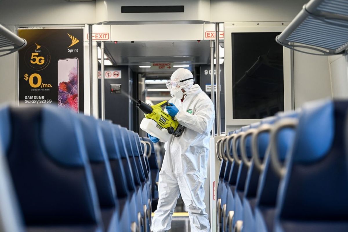 Hicksville, N.Y.: A Long Island Rail Road employee disinfects a train car with an eco-friendly cleaner while at the Hicksville, New York LIRR station on March 19, 2020.