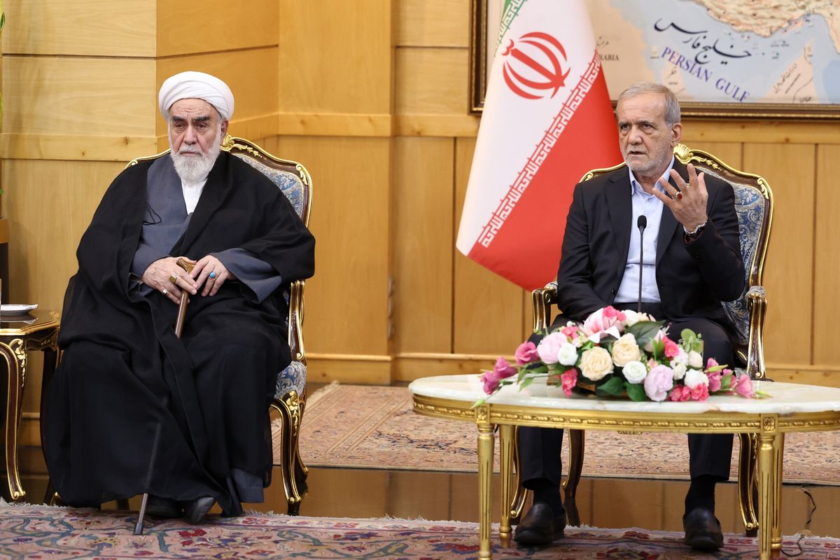 Iranian President Masoud Pezeshkian (R) speaks during a press conference after arriving at Mehrabad Airport in Tehran, Iran on September 27, 2025