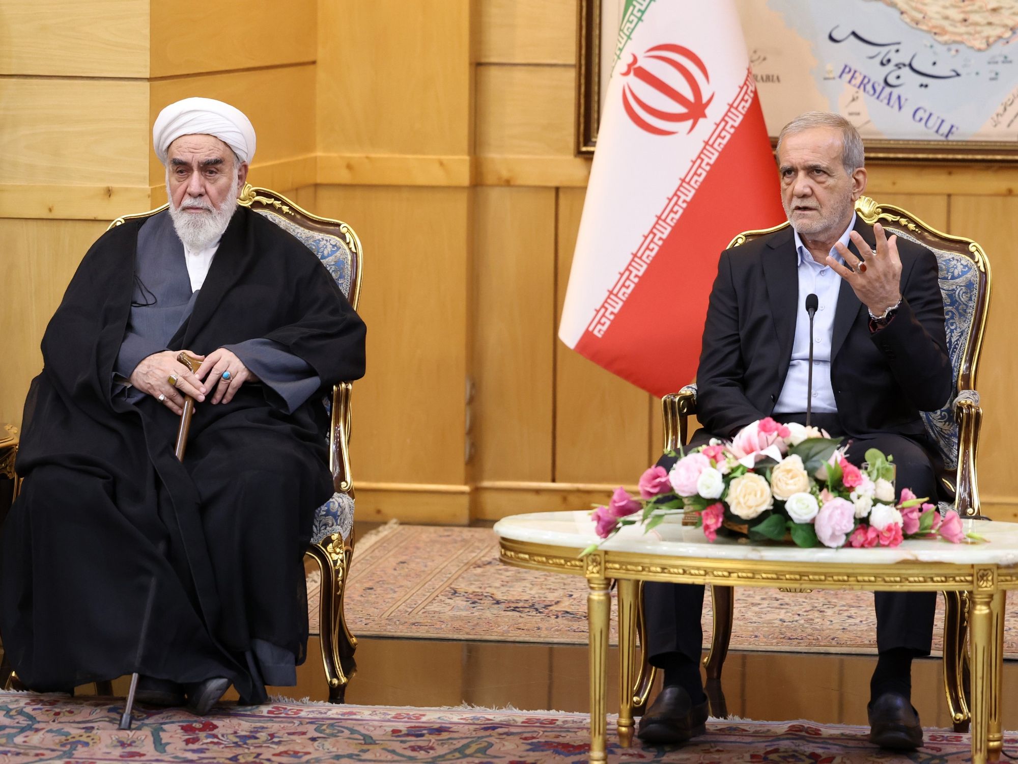 Iranian President Masoud Pezeshkian (R) speaks during a press conference after arriving at Mehrabad Airport in Tehran, Iran on September 27, 2025