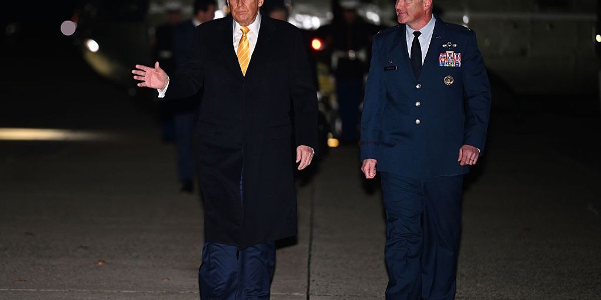 JOINT BASE ANDREWS, MARYLAND - NOVEMBER 14: U.S. President Donald Trump walks with Air Force Colonel Christopher Robinson, Commander of the 89th Airlift Wing, as Trump arrives to board Air Force One on November 14, 2025 at Joint Base Andrew, Maryland.