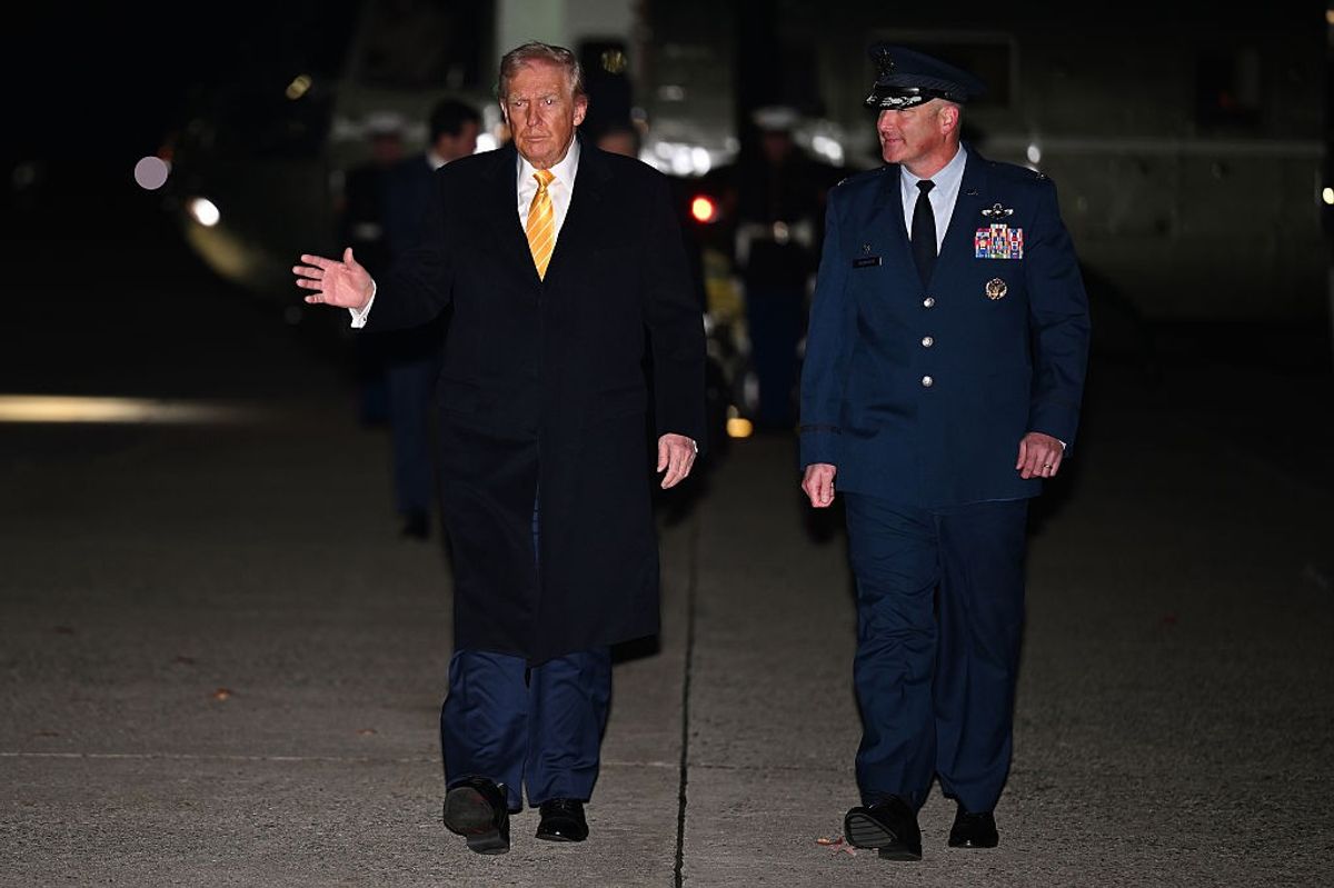 JOINT BASE ANDREWS, MARYLAND - NOVEMBER 14: U.S. President Donald Trump walks with Air Force Colonel Christopher Robinson, Commander of the 89th Airlift Wing, as Trump arrives to board Air Force One on November 14, 2025 at Joint Base Andrew, Maryland.