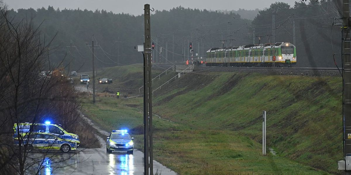 Police investigate at the scene of a damaged section of railway tracks on the Deblin-Warsaw route near the Mika railway station, next to the town of Zyczyn, central Poland, on November 17, 2025