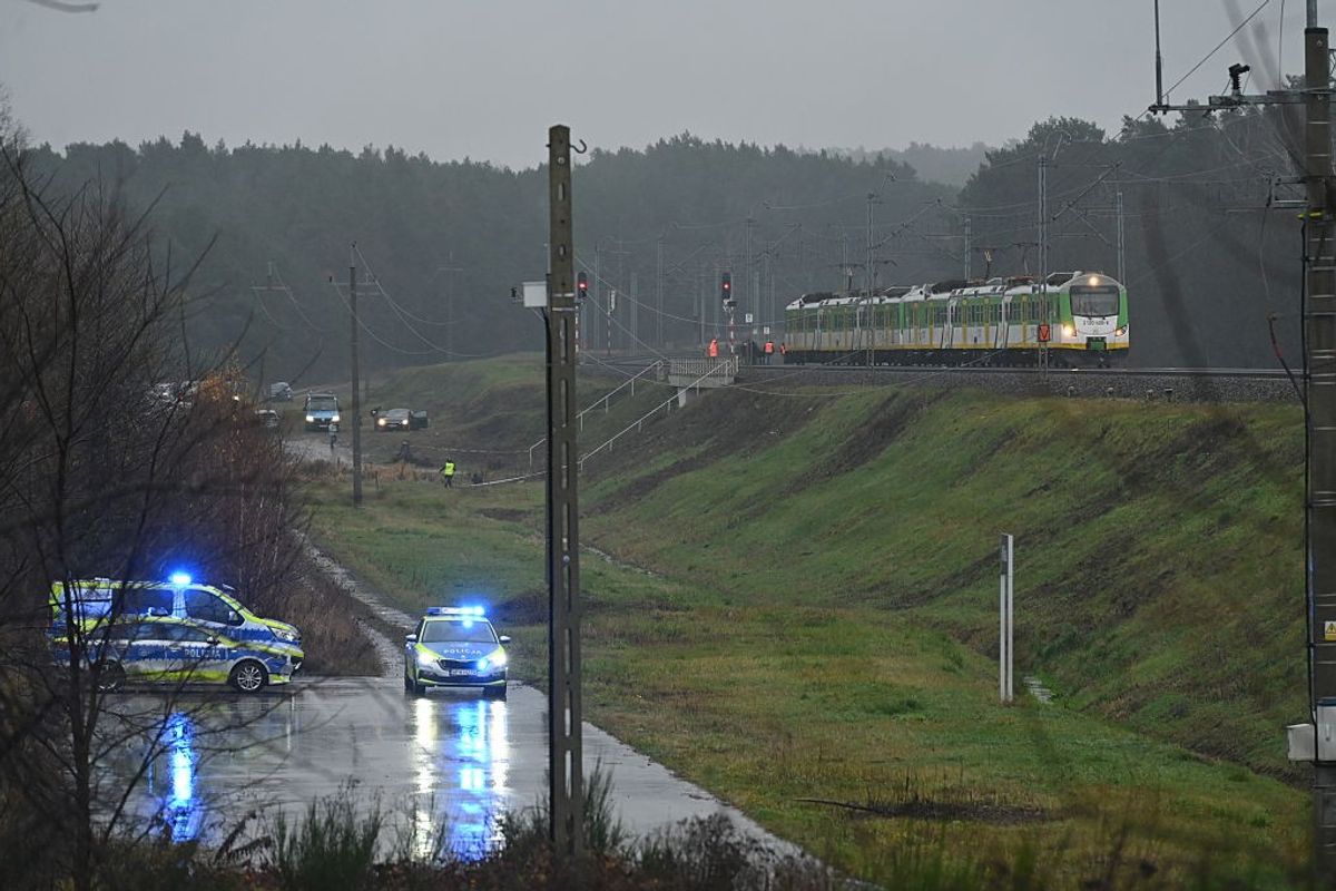 Police investigate at the scene of a damaged section of railway tracks on the Deblin-Warsaw route near the Mika railway station, next to the town of Zyczyn, central Poland, on November 17, 2025