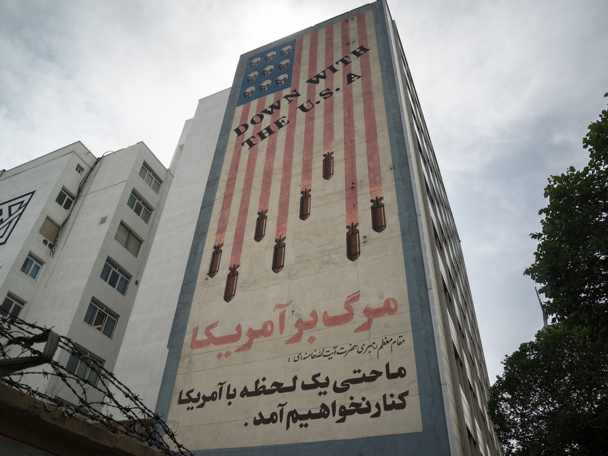 Propaganda paintings with american flag an "Down with the USA text" in Tehran, Iran - stock photo