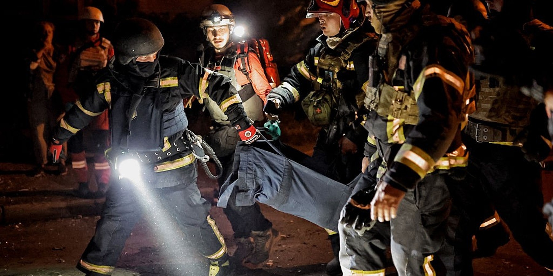 Russia Massively Strikes Kyiv KYIV, UKRAINE - AUGUST 20: Rescuers carry a body on a street at night in a residential area hit by Russian strikes on August 20, 2026 in Kyiv, Ukraine. As a result of the massive Russian attack on Kyiv, damage was recorded in three residential districts of the city. Russian strikes damaged residential buildings, warehouses, a school and a children’s hospital. City authorities report 12 deaths in Kyiv so far. More than 30 people were injured. Tomorrow, August 21, has been declared a Day of Mourning in Kyiv. In memory of the victims of Russia’s massive attack on Kyiv. (Photo by Yan Dobronosov/Global Images Ukraine via Getty Images)