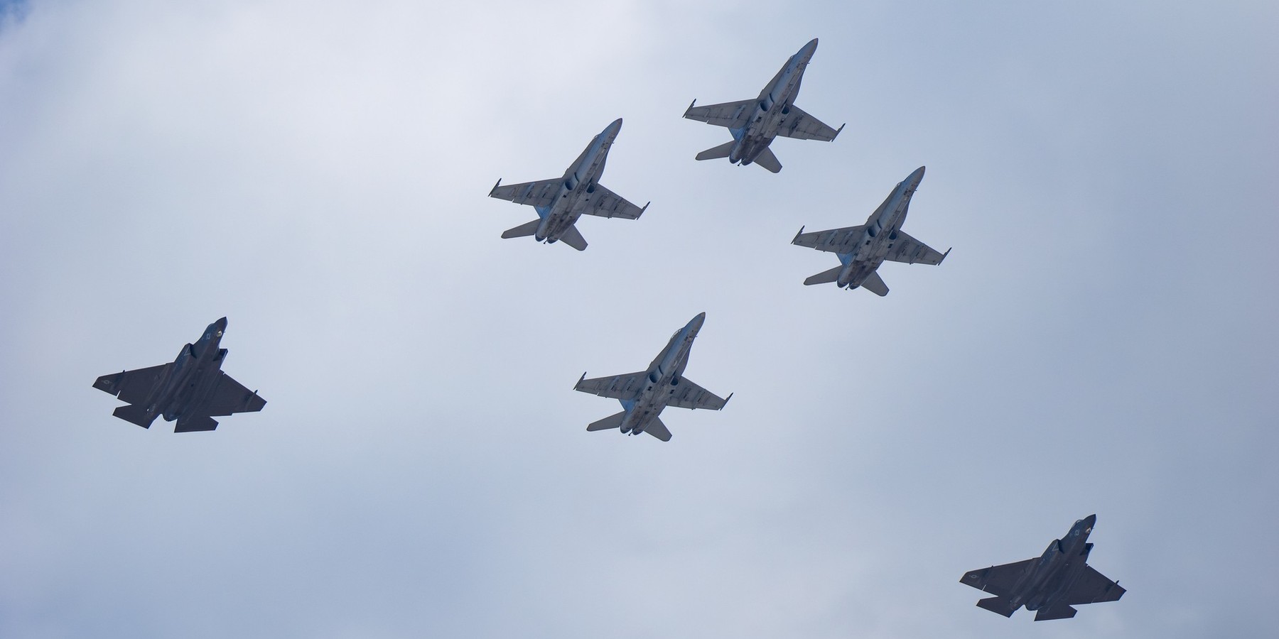 San Diego, California, USA - September 28, 2025: A composite formation flyover featuring four F/A-18 Hornets and two F-35B Lightning II jets during the Marine Air-Ground Task Force demonstration.