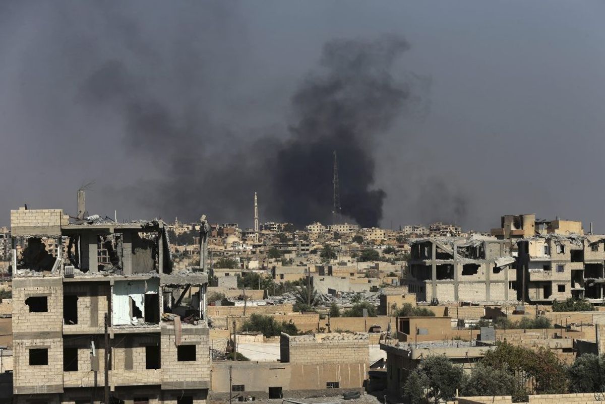 <p>Smoke rises in Raqqa, Syria.</p>