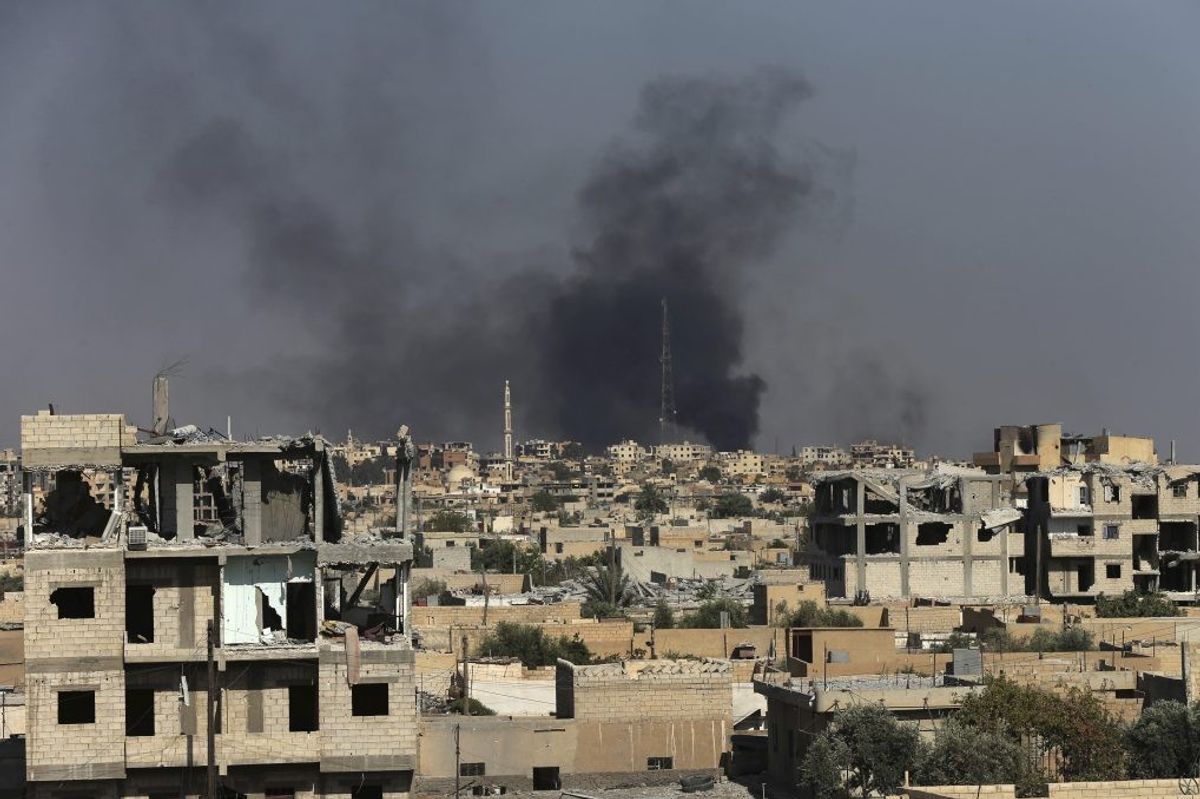 <p>Smoke rises in Raqqa, Syria.</p>