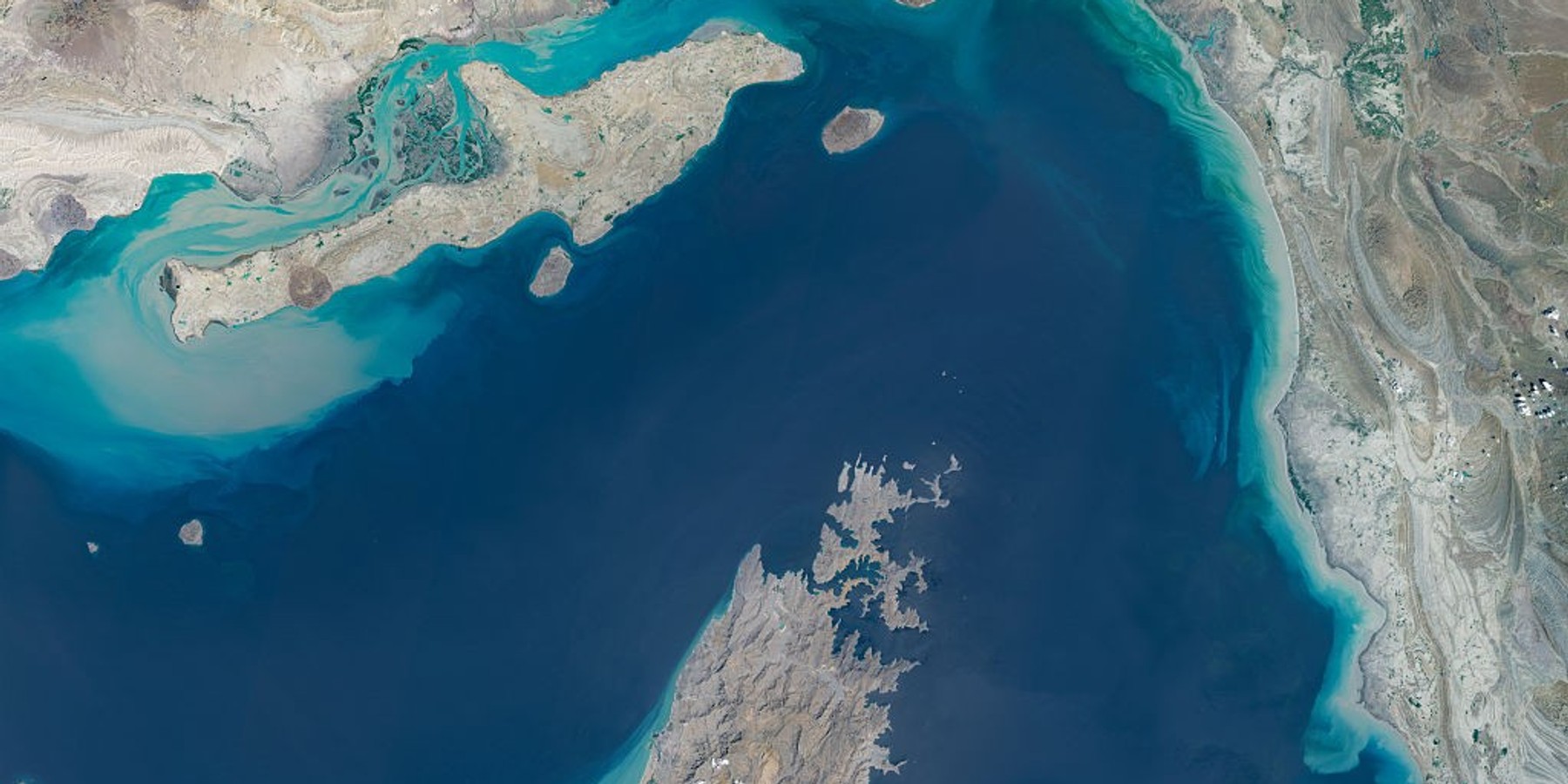 STRAIT OF HORMUZ, IRAN/OMAN -- APRIL 7, 2026: Maps4Media processed and enhanced Sentinal-2 satellite imagery shows a broad view of the Strait of Hormuz between southern Iran and Oman's Musandam Peninsula, including surrounding islands, coastal terrain, and turquoise shallow-water zones at the entrance to the Persian Gulf. The image provides regional context of one of the world's most strategically important maritime chokepoints for global oil and commercial shipping. Please use: Satellite image (c) 2026 Maps4media. (Photo enhanced and published by maps4media via Getty Images)