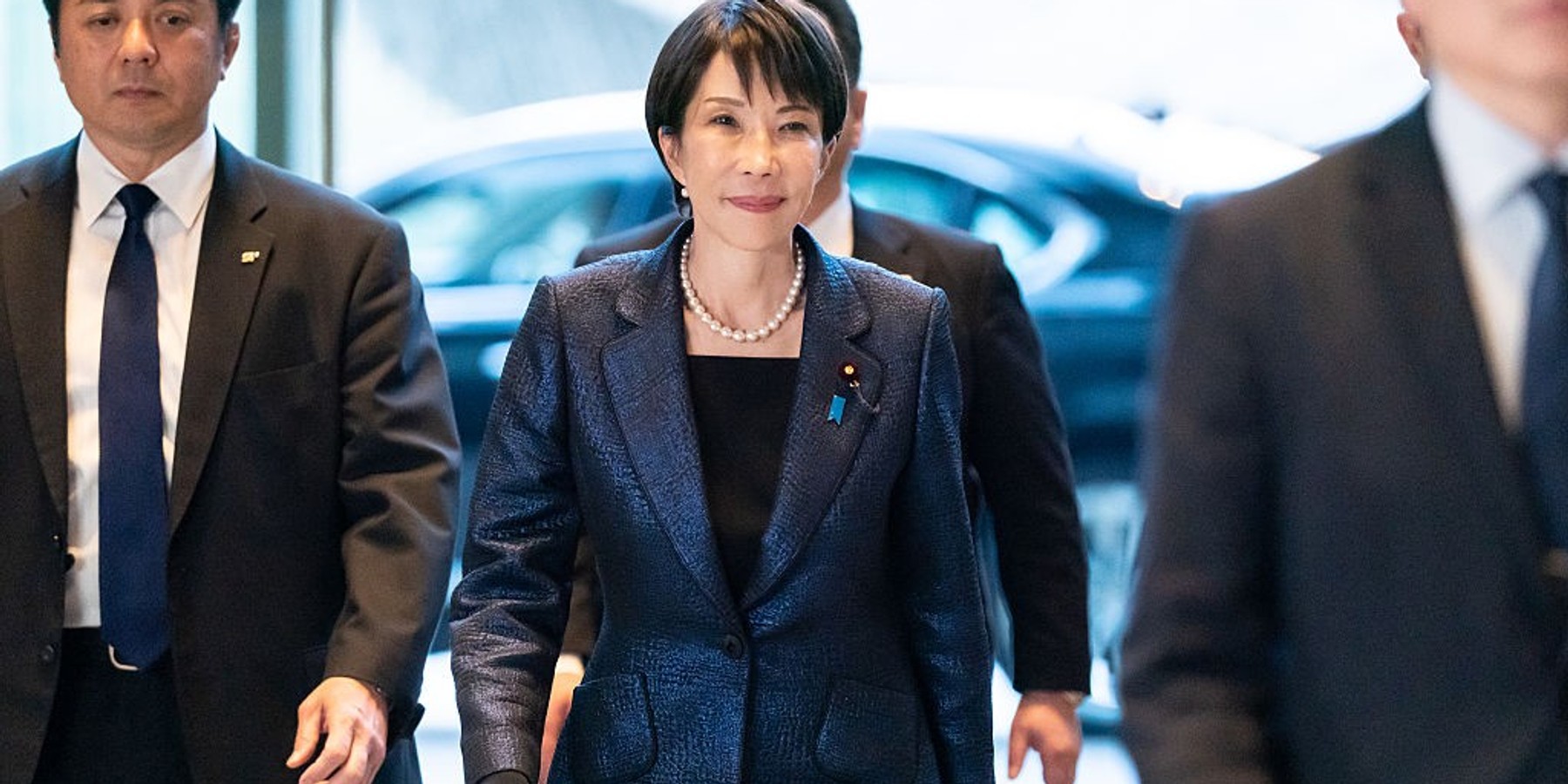 TOKYO, JAPAN - FEBRUARY 18: Japanese Prime Minister Sanae Takaichi (C) arrives at the Prime Minister's Office after being re-elected as prime minister by Parliament on February 18, 2026, in Tokyo, Japan. Takaichi was re-elected by lawmakers following the general election, in which she secured a majority in the Lower House. (Photo by Tomohiro Ohsumi/Getty Images)