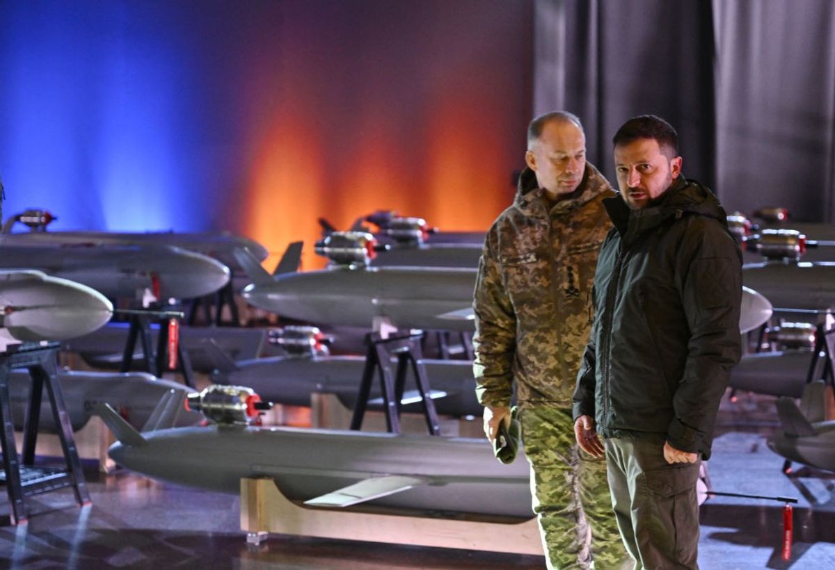 Ukrainian President Volodymyr Zelensky (R) and Commander-in-Chief of the Armed Forces of Ukraine Oleksandr Syrsky (L) speak next to the first batch of Ukrainian made drone missiles "Peklo" (Hell) delivered to the Defence Forces of Ukraine in Kyiv on December 6, 2024, amid the Russian invasion of Ukraine.
