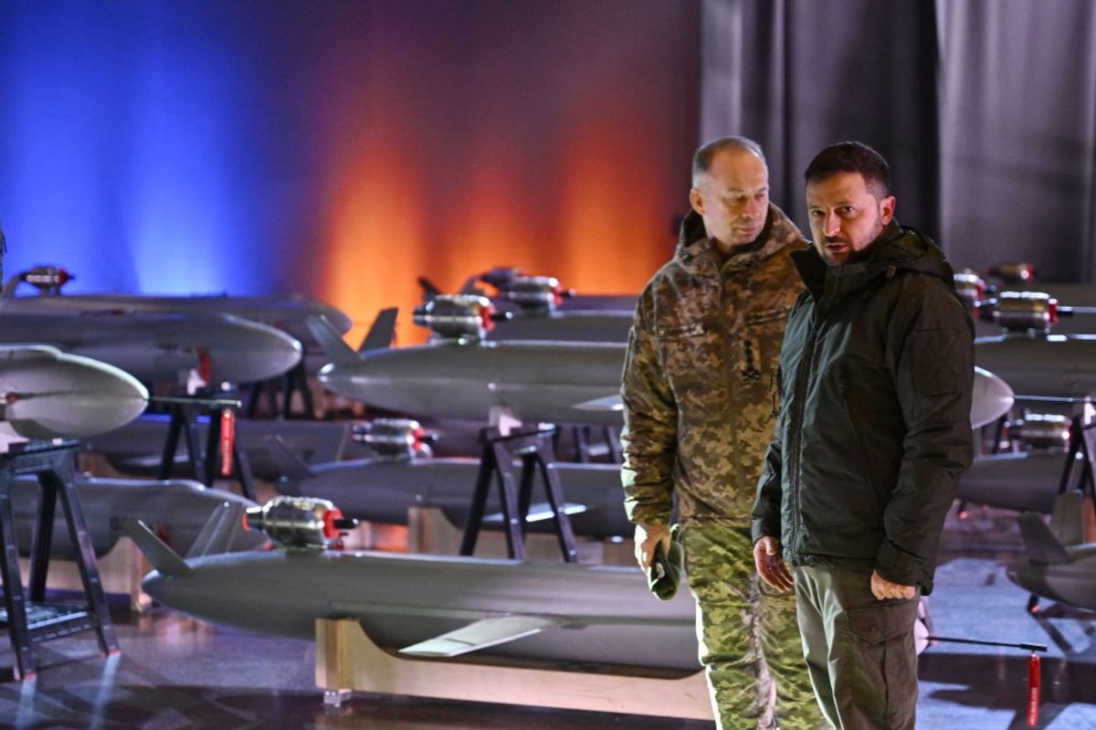 Ukrainian President Volodymyr Zelensky (R) and Commander-in-Chief of the Armed Forces of Ukraine Oleksandr Syrsky (L) speak next to the first batch of Ukrainian made drone missiles "Peklo" (Hell) delivered to the Defence Forces of Ukraine in Kyiv on December 6, 2024, amid the Russian invasion of Ukraine.