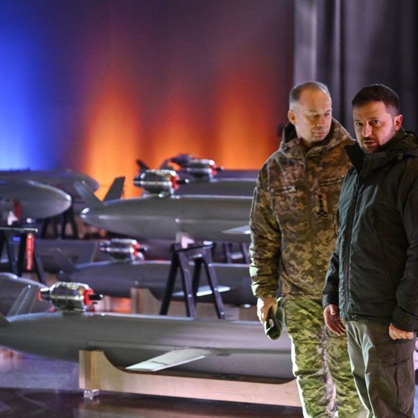 Ukrainian President Volodymyr Zelensky (R) and Commander-in-Chief of the Armed Forces of Ukraine Oleksandr Syrsky (L) speak next to the first batch of Ukrainian made drone missiles "Peklo" (Hell) delivered to the Defence Forces of Ukraine in Kyiv on December 6, 2024, amid the Russian invasion of Ukraine.