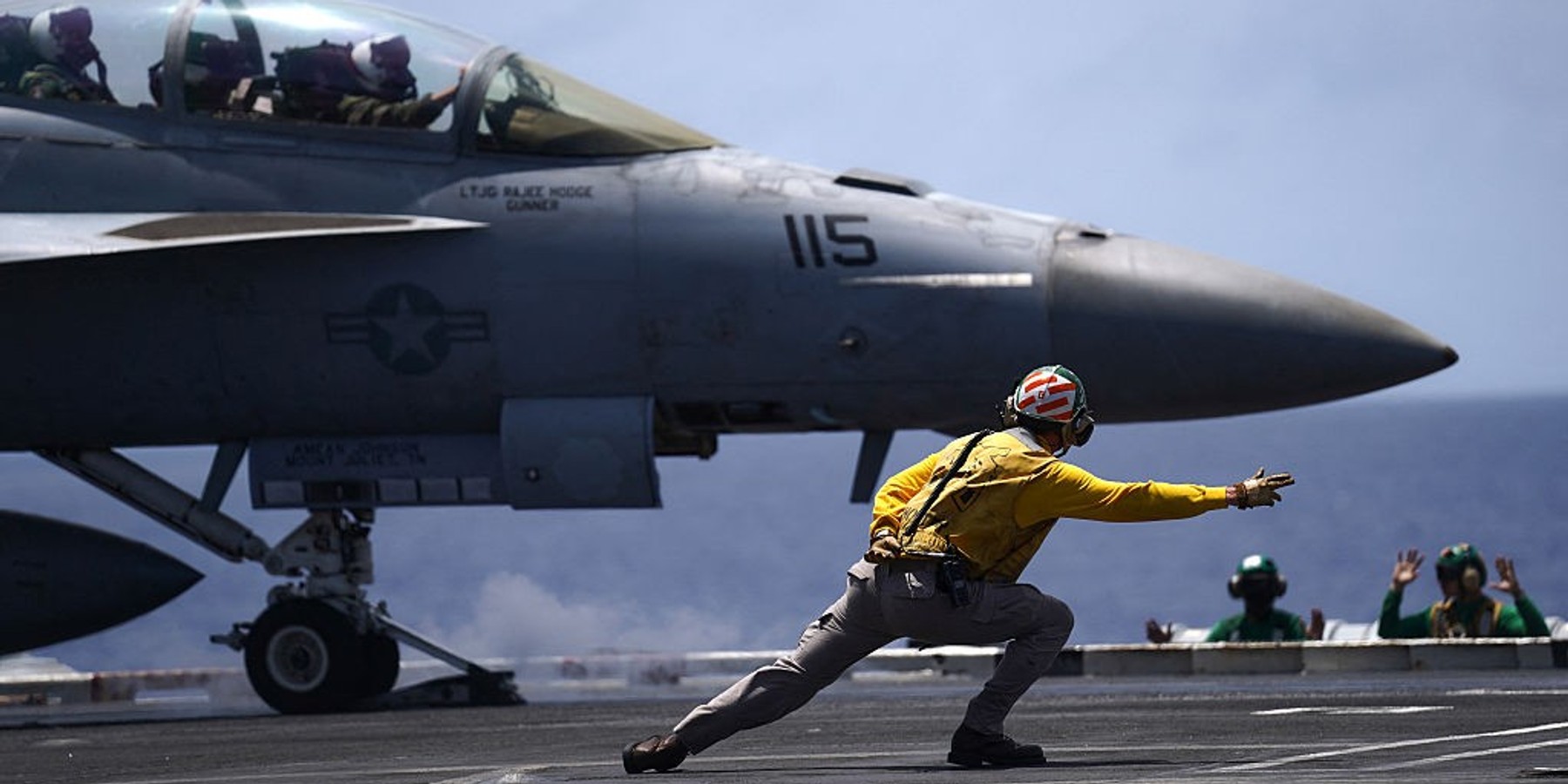 US-MILITARY-RIMPAC-ARMAMENT A US Navy aviation boatswain's mate directs a F/A-18F Super Hornet assigned to Strike Force Squadron (VFA) 154 on the flight deck aboard the aircraft carrier USS Theodore Roosevelt (CVN-71) while the ship is moored in Honolulu, Hawaii, during Exercise RIMPAC (Rim of the Pacific) 2026 on July 17, 2026. (Photo by Michelle Bir / AFP via Getty Images)