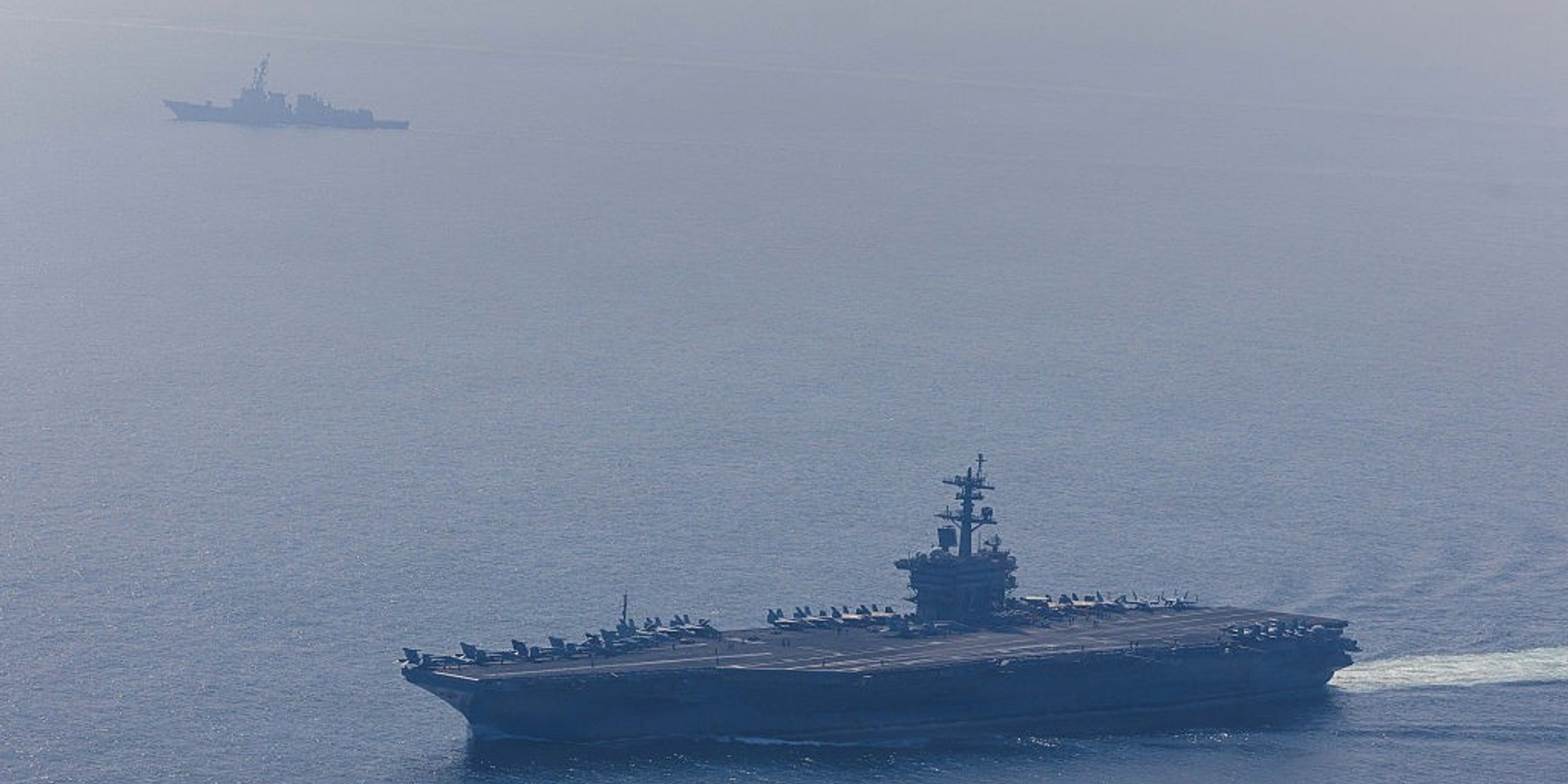 USS Abraham Lincoln Carrier Strike Group In Arabian Sea (EDITOR'S NOTE: This Handout image was provided by a third-party organization and may not adhere to Getty Images' editorial policy.) In this handout photo obtained from the U.S. Defence Department, Nimitz-class aircraft carrier USS Abraham Lincoln (CVN 72) and Arleigh Burke-class guided-missile destroyer USS Frank E. Petersen Jr. (DDG 121) sail in the Arabian Sea, Feb. 6, 2026. According to the U.S. government, the Abraham Lincoln Carrier Strike Group is deployed to the U.S. 5th Fleet area of operations to support maritime security and stability in the Middle East. The deployment to the region comes as the U.S. continues to put pressure on Iran over its nuclear program and its response to recent anti-government protests. (Handout photo by Mass Communication Specialist 1st Class Jesse Monford/U.S. Navy via Getty Images)